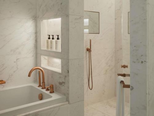 a bathroom with a sink and a shower at Delano Dubai at Bluewaters in Dubai