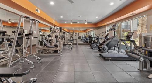 a gym with several treadmills and elliptical machines at Luxury Skyline Escape, FIFA World Cup, King Bed, Free Parking, DT View, Sauna in Dallas
