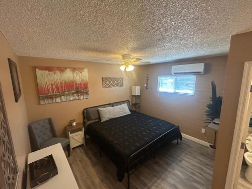 a bedroom with a bed and a ceiling fan at Love nest in Bullhead City