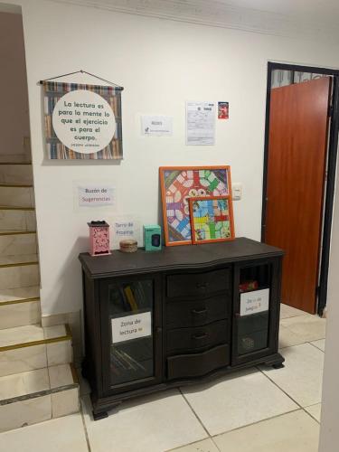 a wooden cabinet sitting in a room next to a wall at Casa Vacacional Villavicencio in Villavicencio