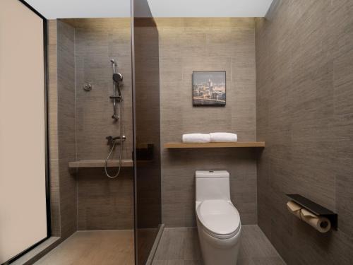 a bathroom with a toilet and a shower at Holiday Inn Express Zhuhai Grand Theater by IHG in Zhuhai