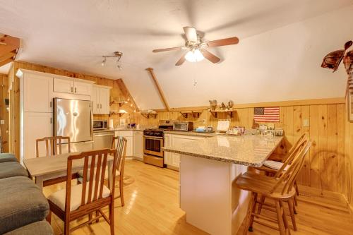 a kitchen with a table and chairs and a ceiling fan at Walk to Beach and Playground Charming Madison Cabin in Albany