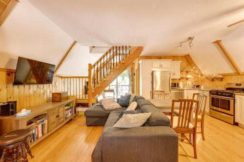 a large living room with a couch and a kitchen at Walk to Beach and Playground Charming Madison Cabin in Albany