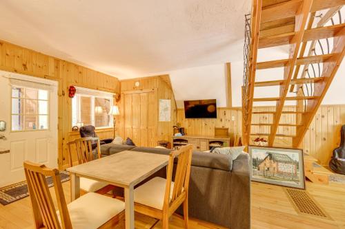 a living room with a couch and a table at Walk to Beach and Playground Charming Madison Cabin in Albany