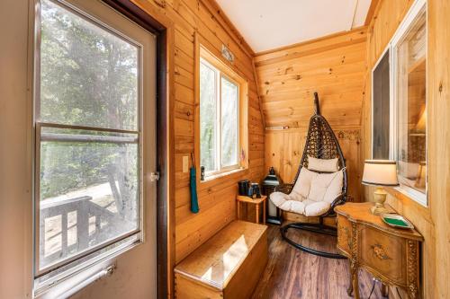 a room with a hammock in a cabin with a window at Walk to Beach and Playground Charming Madison Cabin in Albany
