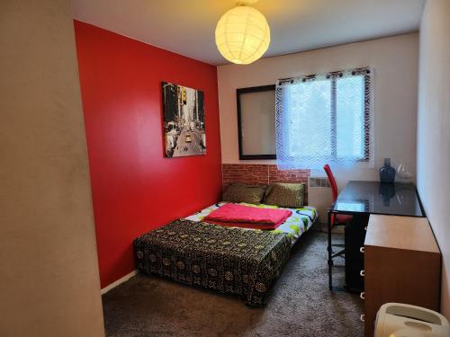 a bedroom with a bed and a red wall at 69Room69 in Lyon