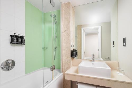 a bathroom with a sink and a shower at Holiday Inn Manchester-Mediacityuk by IHG in Manchester