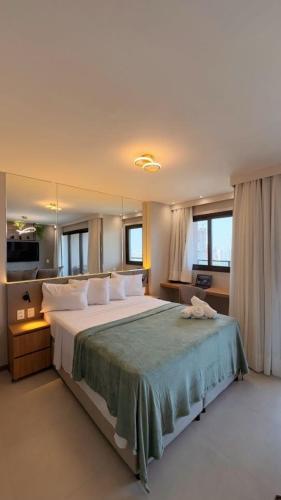 フォルタレザにあるElegância e conforto a passos da Beira-marの白い枕が付いた大きなベッドのある寝室