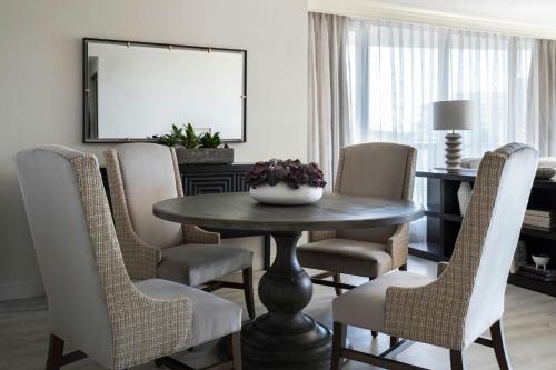 a dining room with a table and chairs at Victoria Marriott Inner Harbour in Victoria