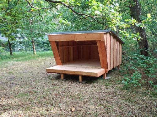 a wooden out house with a bench in a field at 4 star holiday home in in Give