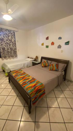 a bedroom with two beds in a room at Cantinho do Litoral Salvador in Salvador
