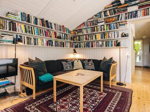a living room with a couch and a table at 8 person holiday home in Tisvildeleje in Tisvildeleje