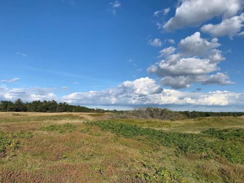 an open field with a blue sky and clouds at 8 person holiday home in Tisvildeleje in Tisvildeleje