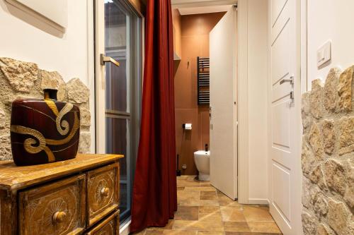 a bathroom with a toilet and a red curtain at Dimora Milù in Foggia
