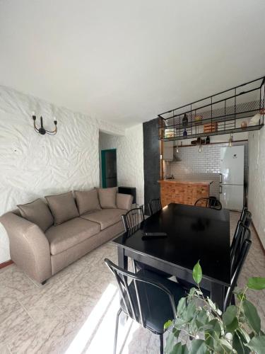 a living room with a couch and a table at Casa Toninas - Playa Unión in Playa Unión