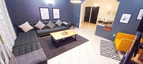 a living room with a couch and a table at Budget-Friendly Apartment Near AirPort in Nouaseur