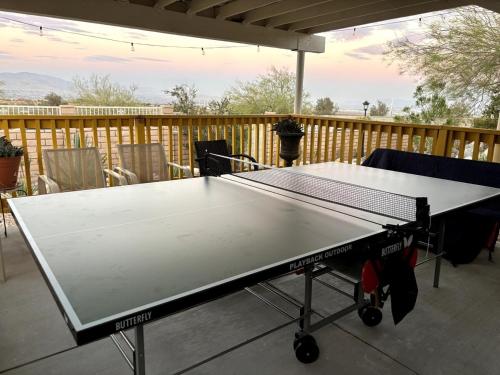 a ping pong table sitting on a patio at Yellow Cactus Oasis in White Water