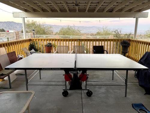 a ping pong table on a patio with a table at Yellow Cactus Oasis in White Water