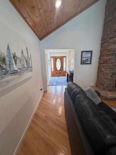 a living room with a couch and a brick wall at Sunset Cove Retreat in Hardin