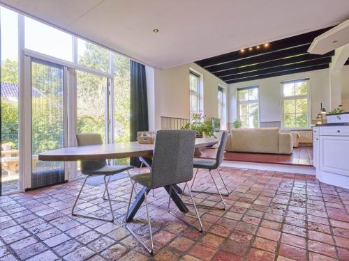 a kitchen and dining room with a table and chairs at t Voorhuis Kolderveen in Nijeveen