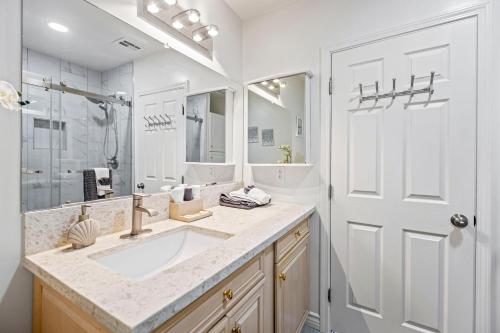 a bathroom with a sink and a large mirror at 4 Room- Local VIBE Retreat just 12 min to The Strip and Fremont in Las Vegas