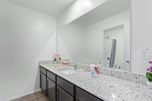 a bathroom with a sink and a large mirror at Cute and cozy Homes in Buckeye in Buckeye