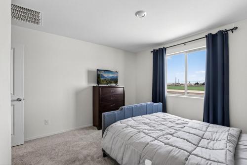 a bedroom with a bed and a window at Cute and cozy Homes in Buckeye in Buckeye