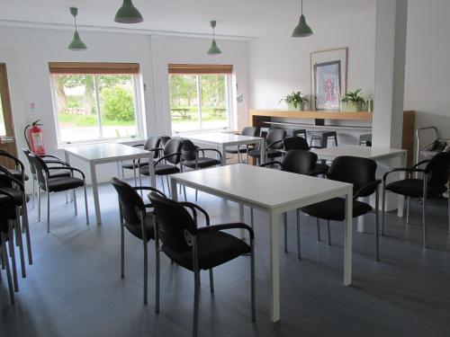 
a dining room with chairs, tables, and tables in it at Hartfield House Hostel in Applecross
