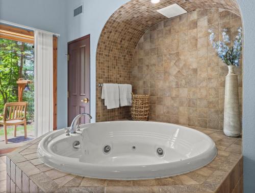 a bathroom with a large tub in a room at Indoor Water Park - Game Rm - Mins to Downtown - Jacuzzi in Wisconsin Dells