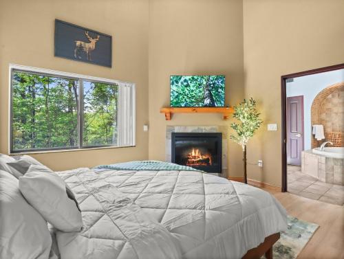 a bedroom with a bed and a fireplace at Indoor Water Park - Game Rm - Mins to Downtown - Jacuzzi in Wisconsin Dells