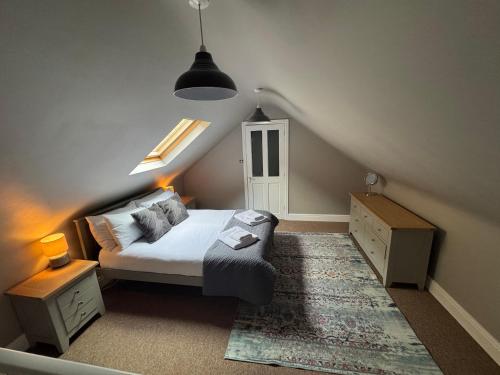 ein kleines Schlafzimmer mit einem Bett und einer Treppe in der Unterkunft Sunset Cottage in Hunstanton