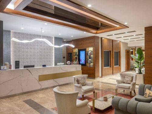 a lobby with chairs and a bar in a building at Mercure Ankara Kızılay in Ankara