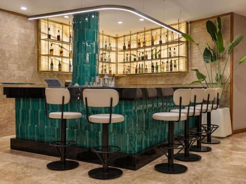 a bar with a row of stools in a room at Mercure Ankara Kızılay in Ankara