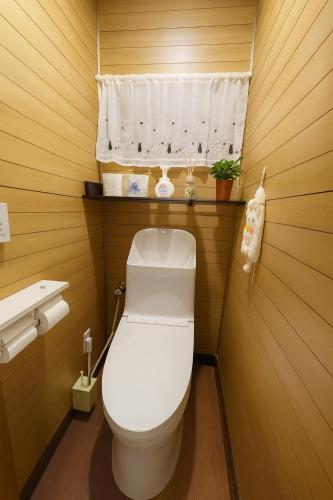 a small bathroom with a toilet and a window at Mie's House Skytree 美英軒 in Tokyo