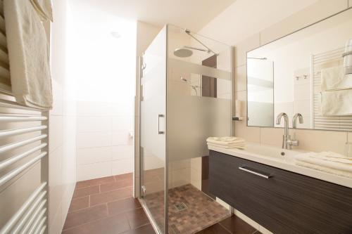 a bathroom with a glass shower and a sink at Ferienzimmer Paunger in Miesenbach