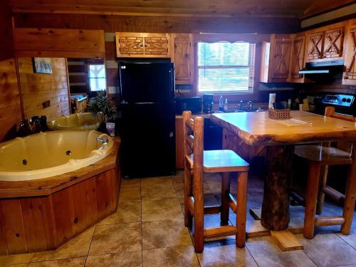 a kitchen with a tub and a kitchen with a table at Witt's End in Sevierville
