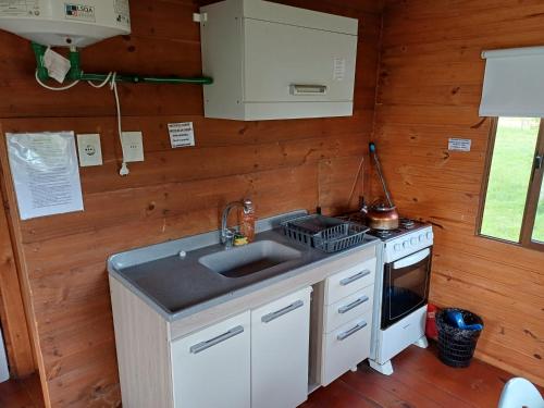 a kitchen with a sink and a stove at Casa para 5 personas in Juan L. Lacaze