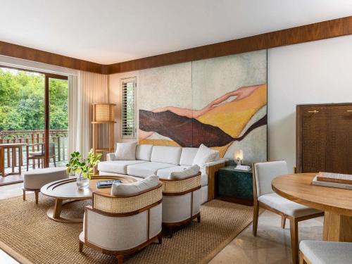 a living room with a couch and a table at Fairmont Mayakoba in Playa del Carmen
