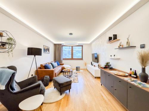 a living room with a couch and a table at Apartmán Na Pomezí in Valtice
