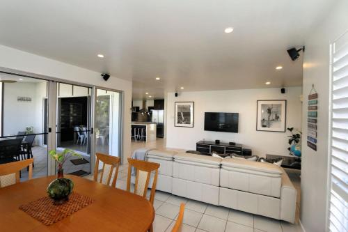 a living room with a couch and a table at 17 Bargara Lakes Drive Bargara in Bargara