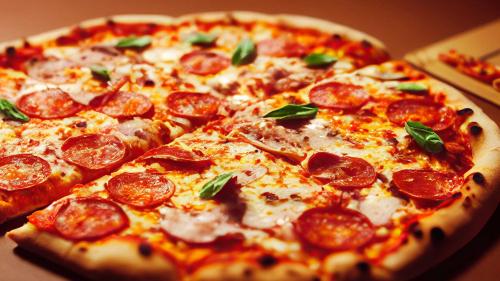 a pepperoni pizza sitting on top of a table at Holiday Inn Acapulco La Isla by IHG in Acapulco