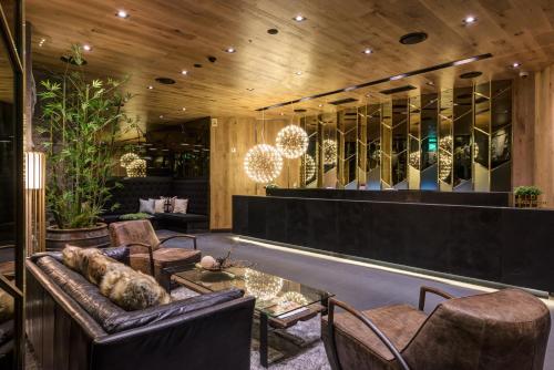 a lobby with a couch and chairs and mirrors at Hotel The Designers Kondae in Seoul