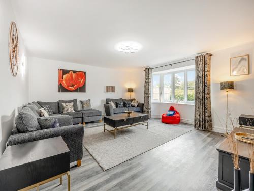 a living room with a couch and a table at Cowslip Cottage - Uk47072 in Maltby le Marsh
