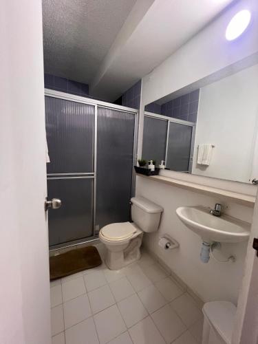 a bathroom with a toilet and a sink at Silvia Maria Lodging House in Valledupar