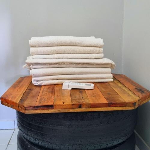 a stack of towels sitting on top of a barrel at Casa 03 in Parnaíba