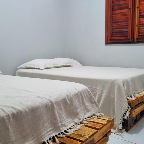 two beds sitting next to each other in a room at Casa 03 in Parnaíba