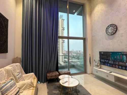 a living room with a large window with a view at Loft 74 Studio's in Gurgaon