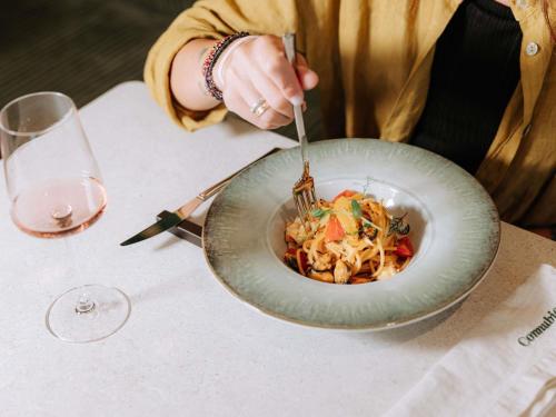 a person sitting at a table with a bowl of food at Mövenpick Hotel Bari in Bari