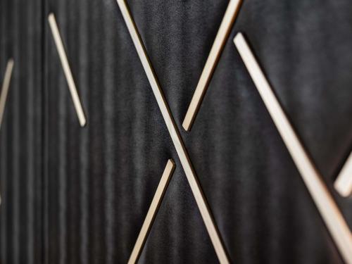 a close up of a clock on a wall at Le Marin Hotel Rotterdam City - Handwritten Collection in Rotterdam