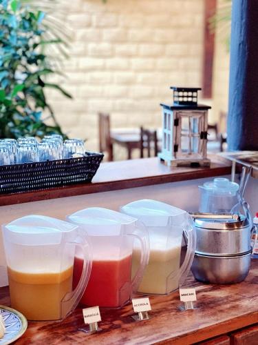three containers of different colored liquid on a table at Villa Medina Jeri in Jericoacoara